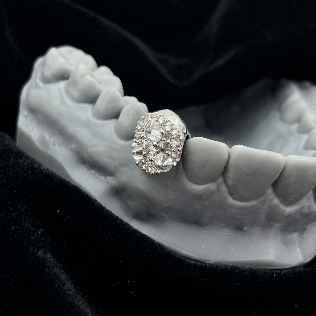 Single diamond tooth cap on black velvet