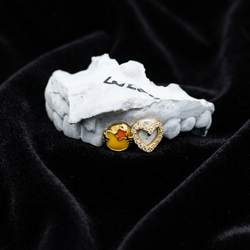 Gold enamel and diamond heart tooth caps on black velvet